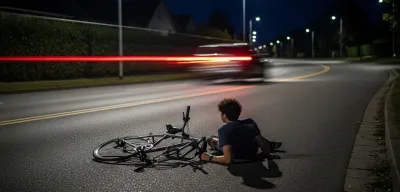 Damaged vehicle alone on residential Portland street with scattered debris and neighbor visible in window
